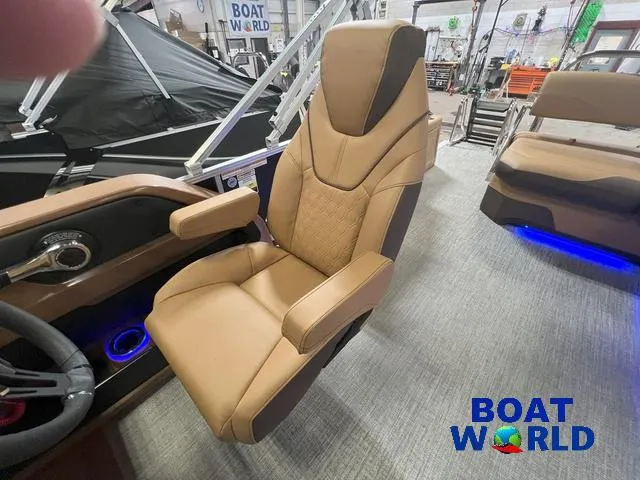 Slide: The Image of 2025 Tahoe LTZ 2385 Cruise Tritoon captain's chair in a showroom setting. - 11