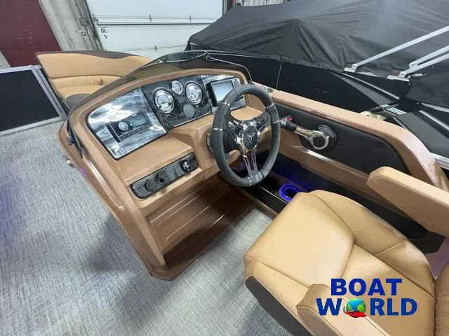 Slide: The Image of 2025 Tahoe LTZ 2385 Cruise Tritoon interior with modern dashboard and steering wheel. - 12