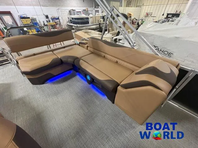 Slide: The Image of 2025 Tahoe LTZ 2385 Cruise Tritoon with luxurious rear bench seating and ambient lighting. - 15