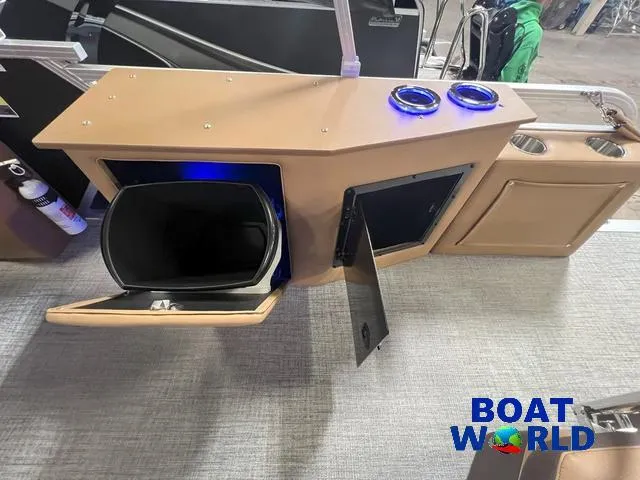 Slide: The Image of 2025 Tahoe LTZ 2385 Cruise Tritoon interior with storage compartments and cup holders. - 18