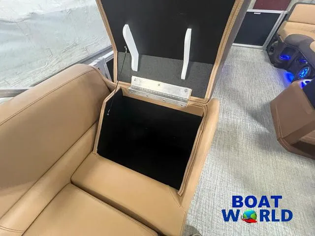 Slide: The Image of 2025 Tahoe LTZ 2385 Cruise Tritoon with open storage bench, beige interior. - 20