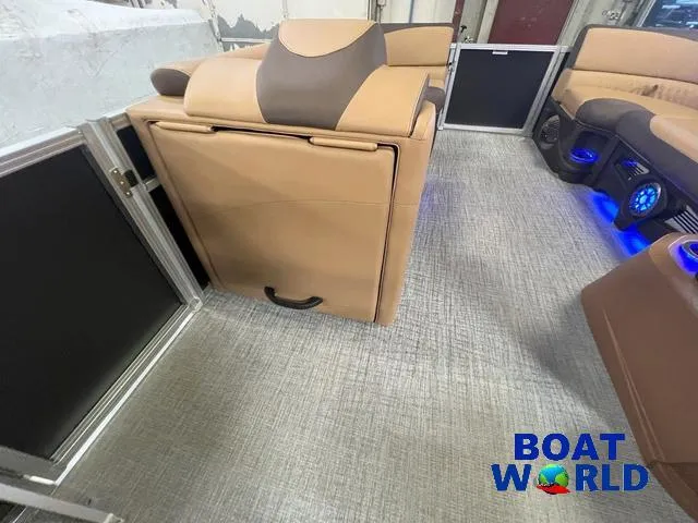 Slide: The Image of 2025 Tahoe LTZ 2385 Cruise Rear Bench Tritoon interior with tan seating and modern design. - 21