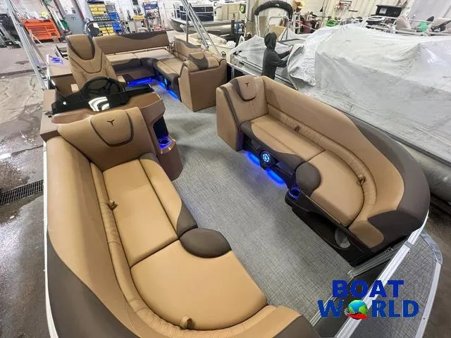 Slide: The Image of 2025 Tahoe LTZ 2385 Cruise Tritoon with luxurious seating and ambient lighting. - 24
