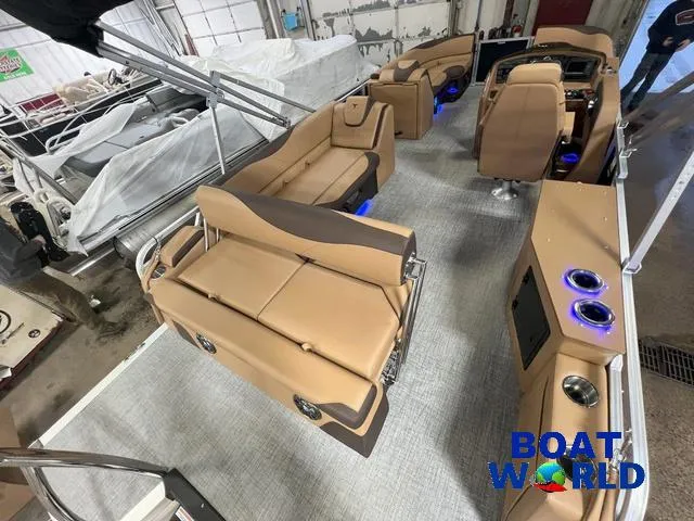 Slide: The Image of 2025 Tahoe LTZ 2385 Cruise Tritoon with luxurious tan seating and modern interior design. - 25