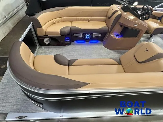 Slide: The Image of 2025 Tahoe LTZ 2385 Cruise Tritoon with luxurious tan seating and modern interior design. - 3