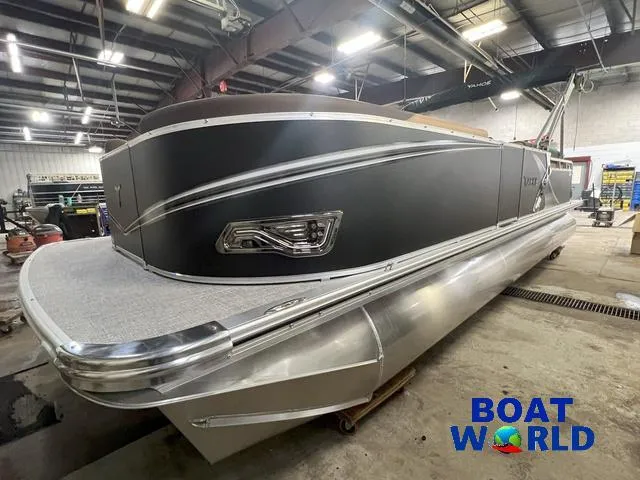 Slide: The Image of 2025 Tahoe LTZ 2385 Cruise Rear Bench Tritoon in showroom, featuring sleek design and modern amenities. - 31