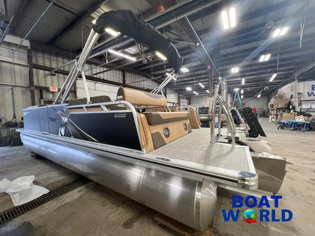 Slide: The Image of 2025 Tahoe LTZ 2385 Cruise Rear Bench Tritoon in warehouse, Boat World logo visible. - 32
