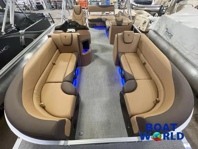 Slide: The Image of 2025 Tahoe LTZ 2385 Cruise Tritoon with luxurious seating and ambient lighting. - 6