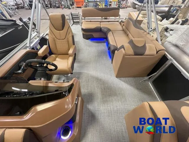 Slide: The Image of 2025 Tahoe LTZ 2385 Cruise Tritoon interior with tan seating and blue LED lighting. - 9