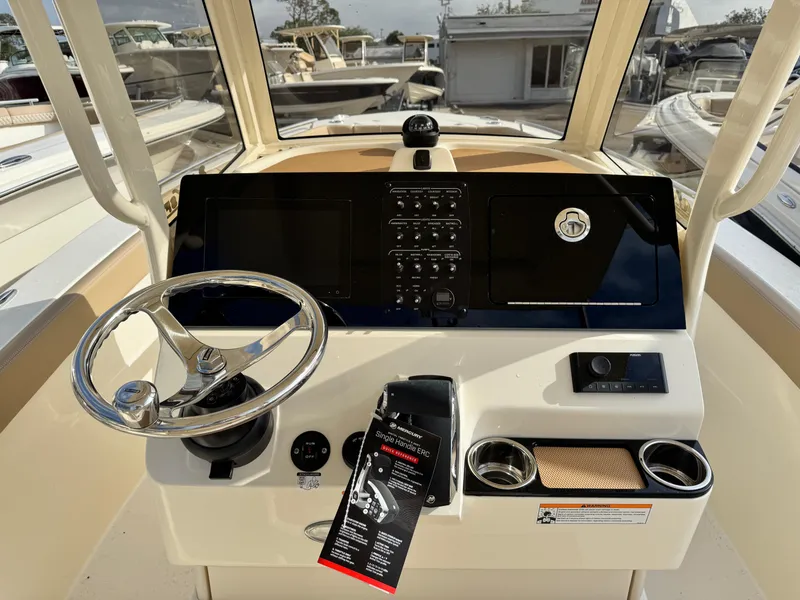 Slide: The Image of 2025 Scout 240 XSF boat dashboard with steering wheel and control panel. - 10