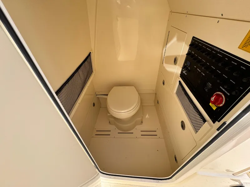 Slide: The Image of 2025 Scout 240 XSF boat interior with toilet and control panel. - 11