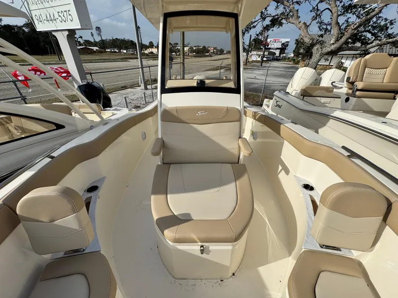 Slide: The Image of 2025 Scout 240 XSF boat interior with beige seating and modern design. - 14
