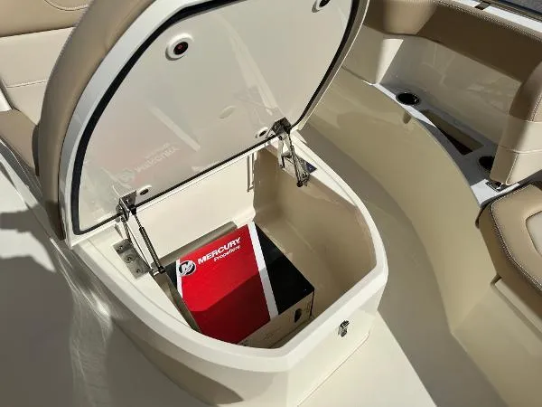 Slide: The Image of Open storage compartment in 2025 Scout 240 XSF boat with Mercury box inside. - 15