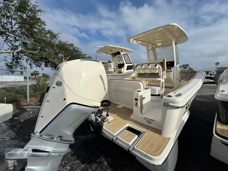 Slide: The Image of 2025 Scout 240 XSF boat with powerful outboard motor, sleek design, and spacious deck. - 2