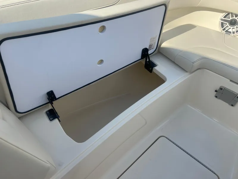 Slide: The Image of Open storage compartment on 2025 Scout 277 Dorado boat interior. - 10