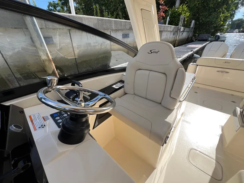 Slide: The Image of 2025 Scout 277 Dorado boat interior with steering wheel and comfortable seating. - 17