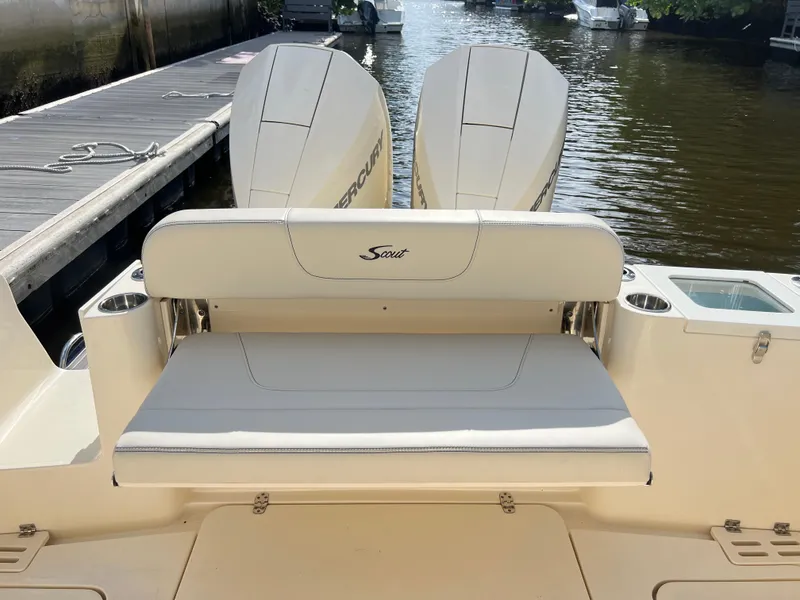 Slide: The Image of 2025 Scout 277 Dorado boat with dual Mercury engines, docked by the water. - 25