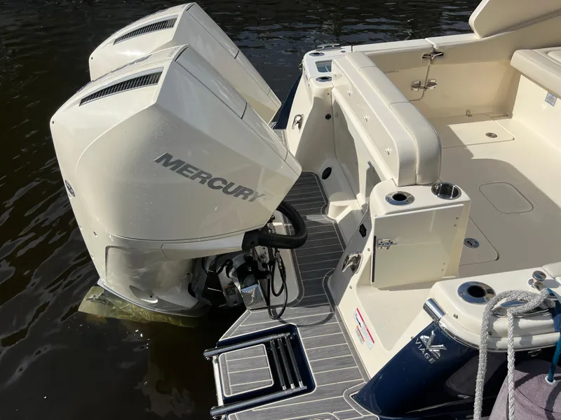 Slide: The Image of 2025 Scout 277 Dorado boat with dual Mercury outboard engines, docked on water. - 28