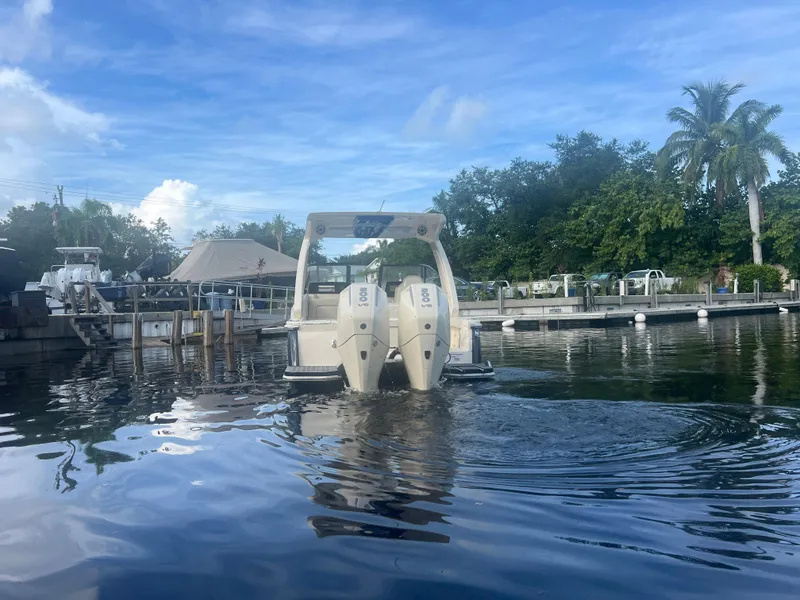 Slide: The Image of 2025 Scout 277 Dorado boat docked on calm water under a clear blue sky. - 5