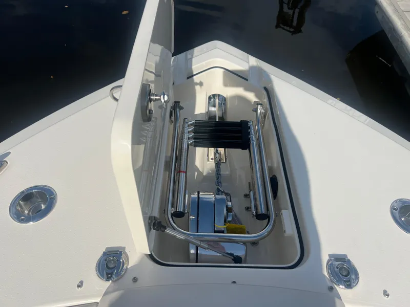 Slide: The Image of 2025 Scout 277 Dorado boat anchor compartment with stainless steel fittings and winch. - 7