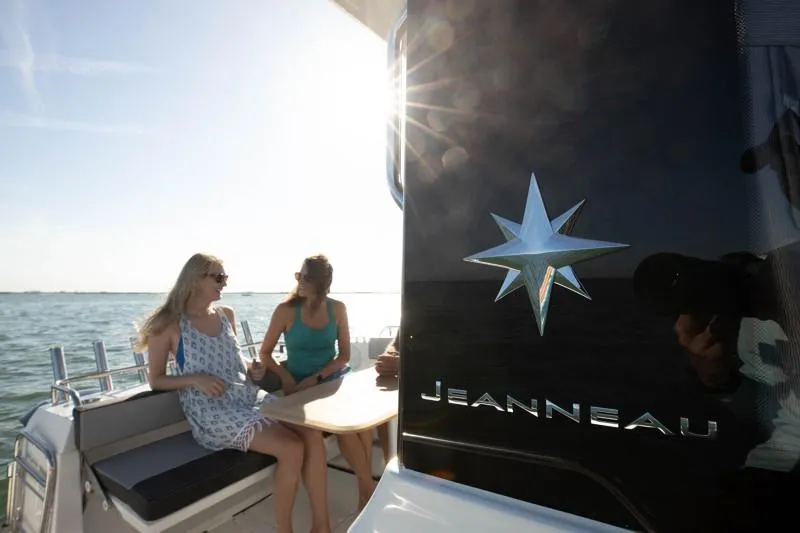 Slide: The Image of 2024 Jeanneau NC Sport 895 boat with two people enjoying the sun. - 13
