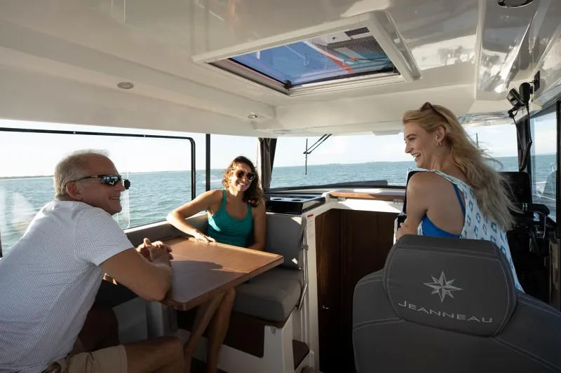Slide: The Image of People enjoying a sunny day inside a 2024 Jeanneau NC Sport 895 boat. - 19