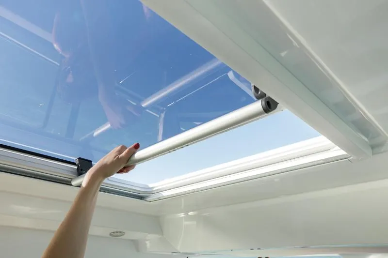 Slide: The Image of Hand opening sunroof on 2024 Jeanneau NC Sport 895 boat. - 22