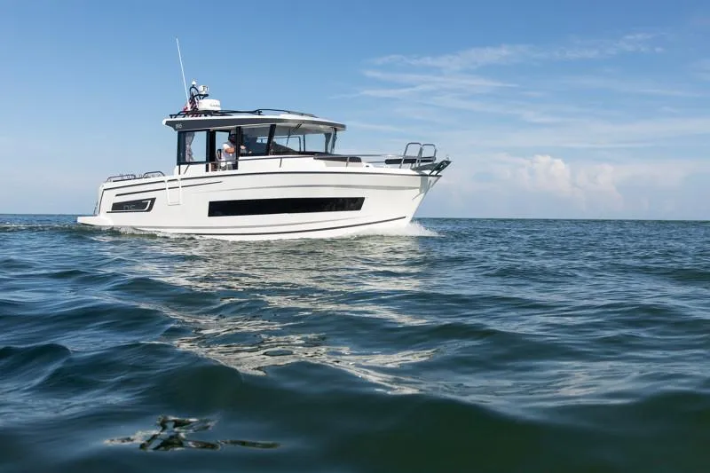 Slide: The Image of 2024 Jeanneau NC Sport 895 cruising on open water under clear skies. - 4