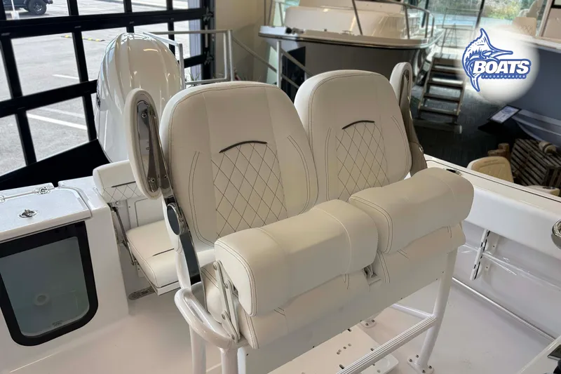 Slide: The Image of 2027 Sportsman Open 212 Center Console boat interior with white cushioned seating. - 8