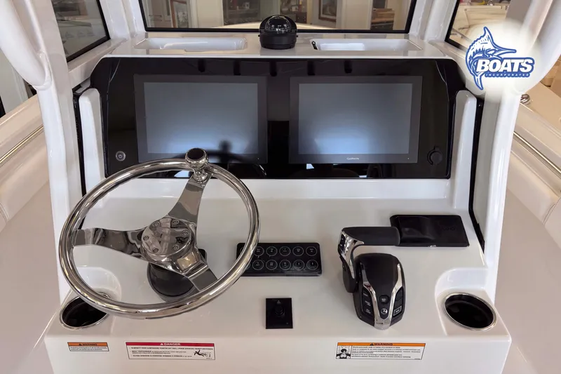 Slide: The Image of 2027 Sportsman Open 212 Center Console dashboard with dual screens and steering wheel. - 7
