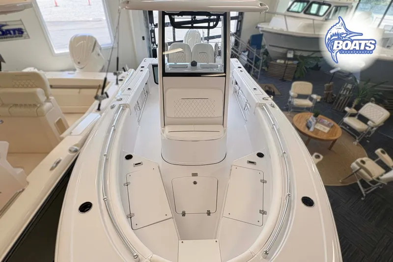 Slide: The Image of 2027 Sportsman Open 212 Center Console boat displayed in a showroom setting. - 4