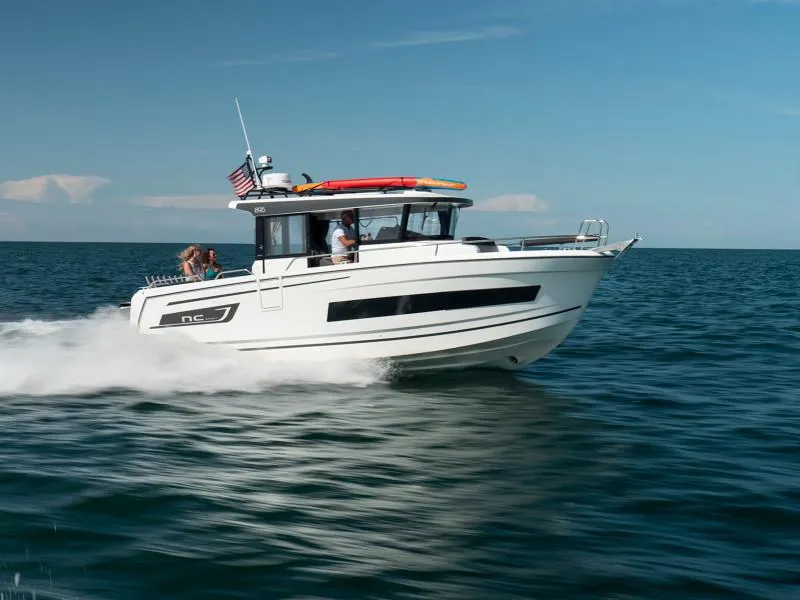 Slide: The Image of 2024 Jeanneau NC Sport 895 cruising on open water under clear skies. - 0