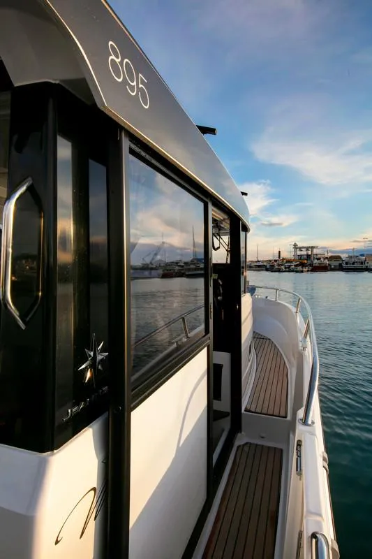 Slide: The Image of 2024 Jeanneau NC Sport 895 boat docked at sunset. - 10