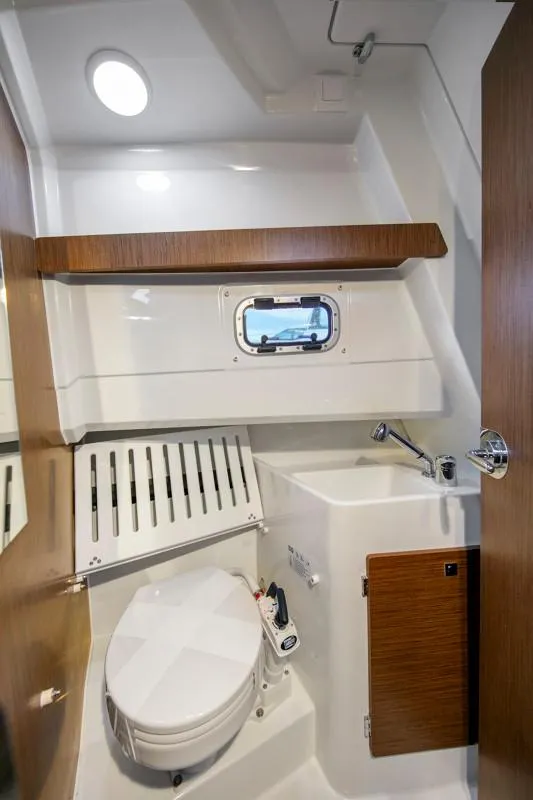 Slide: The Image of 2024 Jeanneau NC Sport 895 boat bathroom with modern fixtures and wood accents. - 17