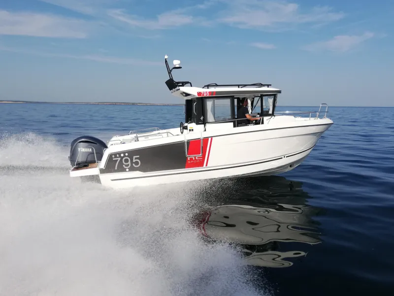 Slide: The Image of 2024 Jeanneau NC 795 Sport speeding on open water. - 0