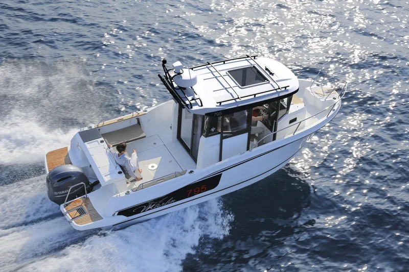 Slide: The Image of 2024 Jeanneau NC 795 Sport boat cruising on open water. - 4