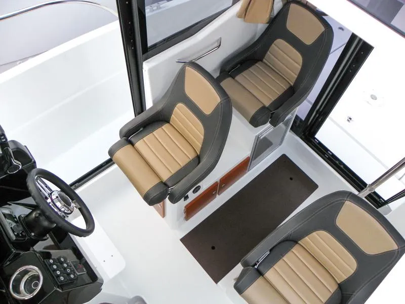 Slide: The Image of 2024 Jeanneau NC 795 Sport interior with three ergonomic seats and modern dashboard. - 5