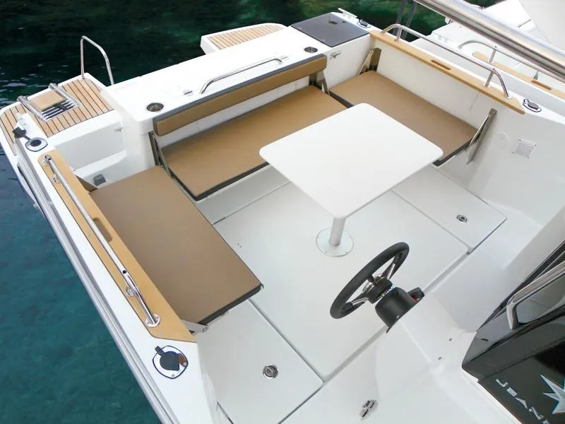 Slide: The Image of 2024 Jeanneau NC 795 Sport boat interior with seating and table. - 6