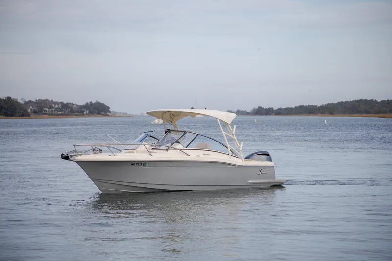 Slide: The Image of 2017 Scout 245 Dorado boat cruising on calm waters. - 4