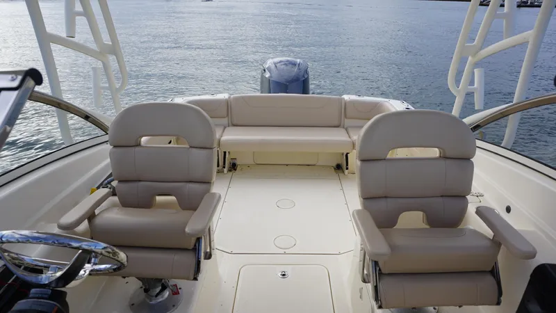 Slide: The Image of 2017 Scout 245 Dorado boat interior with beige seating and steering wheel. - 8