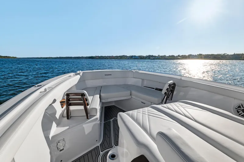 Slide: The Image of 2025 Everglades 375 Center Console boat on serene water, sunny day. - 12