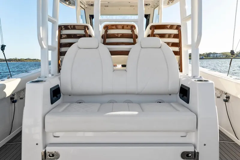 Slide: The Image of 2025 Everglades 375 Center Console boat interior with white seating and ocean view. - 18