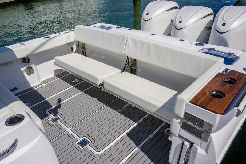 Slide: The Image of 2025 Everglades 375 Center Console boat with white seating and triple outboard engines. - 21