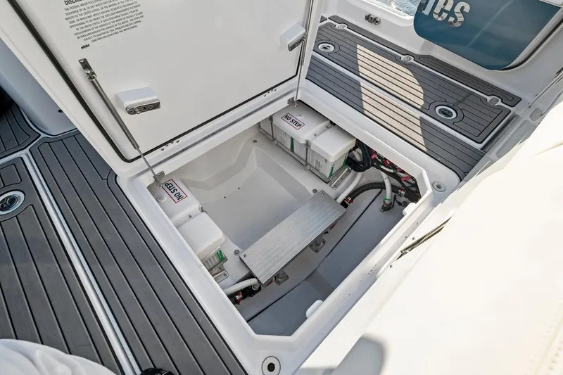 Slide: The Image of 2025 Everglades 375 Center Console boat storage compartment with batteries and wiring. - 22