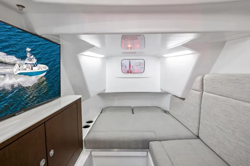 Slide: The Image of Interior of 2025 Everglades 375 Center Console with modern seating and TV. - 25