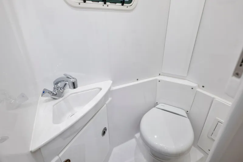 Slide: The Image of 2025 Everglades 375 Center Console boat bathroom interior with sink and toilet. - 29