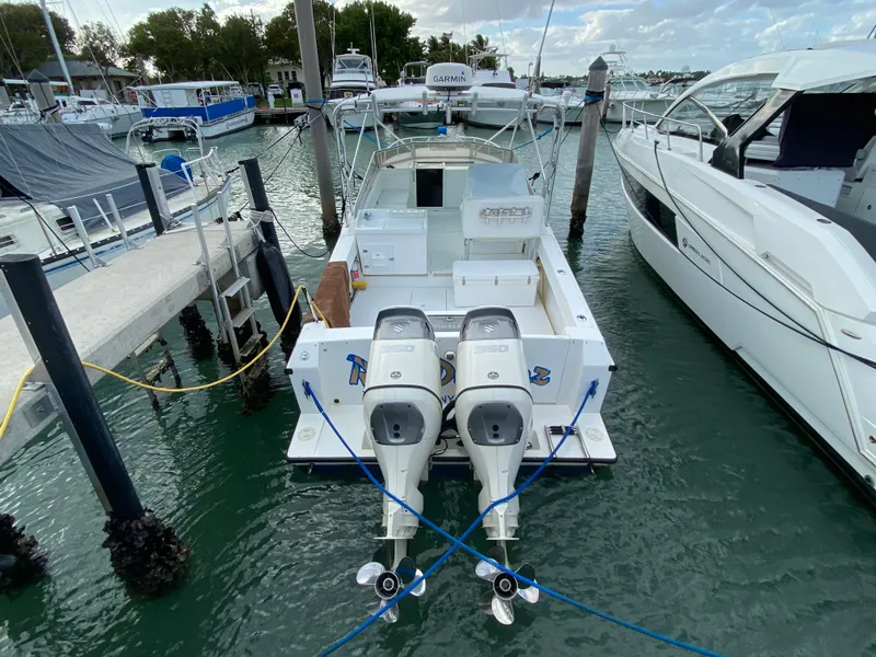 Slide: The Image of 1998 Contender 35 Express boat docked with twin outboard engines. - 2