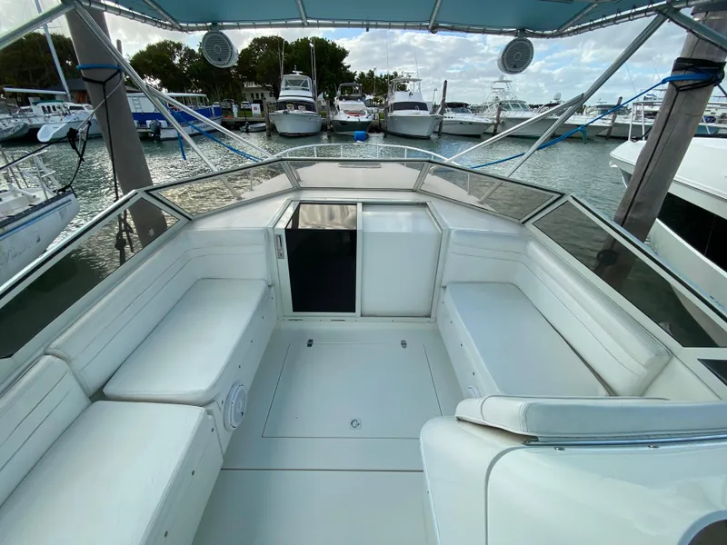 Slide: The Image of 1998 Contender 35 Express boat interior at marina, featuring spacious seating and sleek design. - 25