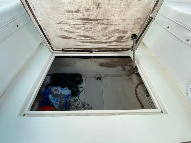 Slide: The Image of Open storage compartment on 1998 Contender 35 Express boat. - 27