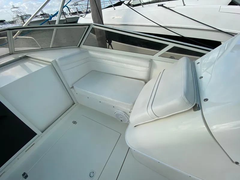 Slide: The Image of 1998 Contender 35 Express boat interior with white seating and spacious deck. - 31